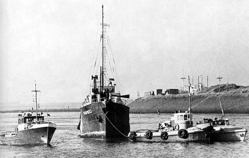 The mv Mi Amigo is towed into IJmuiden harbour